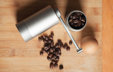 Shiny manual coffee grinder and roasted coffee beans