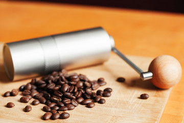 Shiny modern manual coffee grinder and beans