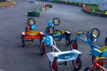 Tricycles for children on the children’s bike path 