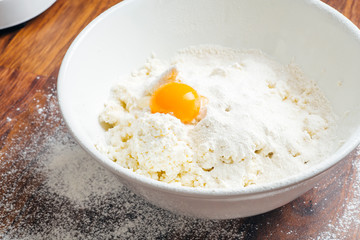 Home cooking and food. Cottage cheese with egg and sugar in a white bowl.