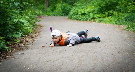 boy fell off a bicycle on the road