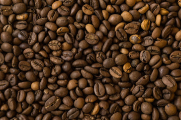 Lots of roasted coffee beans on a white background
