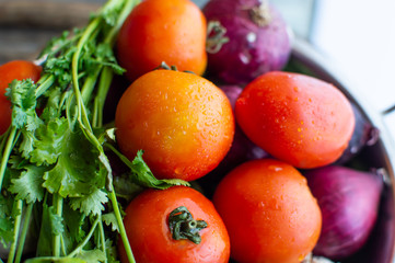 A basket with a lot of vegetables in it