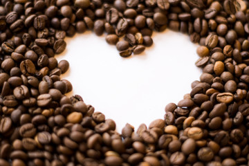 Lots of roasted coffee beans on a white background