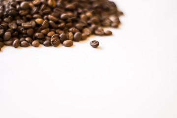 Lots of roasted coffee beans on a white background