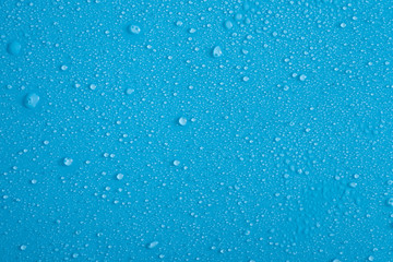 Full frame backdrop of water droplets splatter on blue background