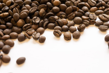 Lots of roasted coffee beans on a white background