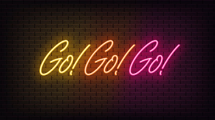 Obraz na płótnie Canvas Neon Go Go Go, lettering. Neon text of Go motivation on black brick background