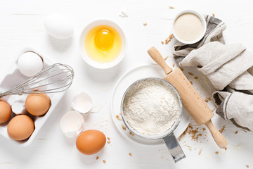 Baking homemade bread on white kitchen worktop with ingredients for cooking, culinary background,...