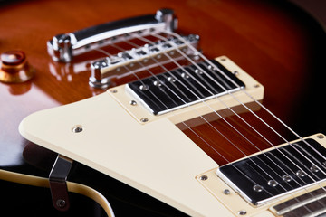 Fototapeta premium close up view for electric guitar. dark moody studio shot. love music concept backdrop.