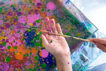 Ebru painting on water. Ancient Turkish art. Abstract bright multi-colored background. Photo liquid...