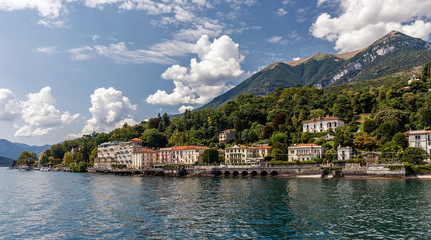 Fototapeta na wymiar Beautiful coastline with old town by the sea in Italy. Wonderful view on popular resort in Cadenabbia town. scenic landscapes of Lago di Como - Cadenabbia, Italy