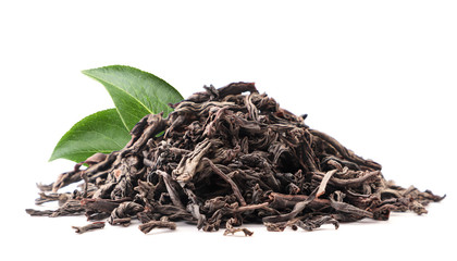 A slide of black tea with green leaves close-up on a white. Isolated