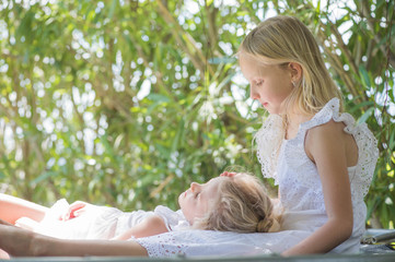 Two sisters playing in the garden, Summertime fun