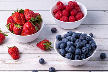 Berries, summer fruits on a wooden table. Healthy lifestyle concept