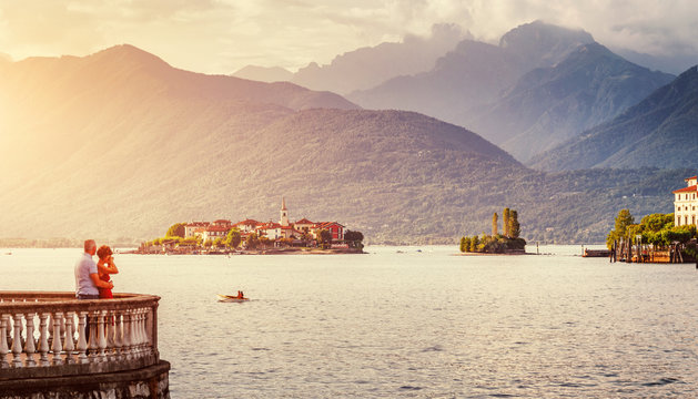 Maggiore lake, Isolla iseland and majestic mountains on background during sunset. Unusual romantic scene. architecture and travel concept.