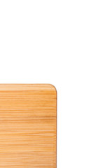 Part of the wooden cutting board and the white background