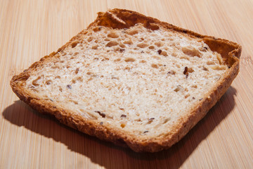 Sliced piece of bread on a wooden table