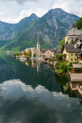 Fototapeta premium Scenic view of the Evangelical church at the waterfront of the famous mountain village Hallstatt in the Salzkammergut region, OÖ, Austria