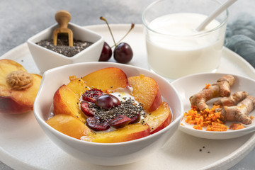 Healing bowl of turmeric, yogurt with chia and fresh fruits