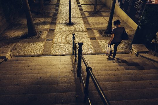 High Angle View Of Woman Walking On Staircase