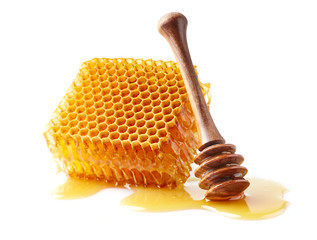 Honeycomb with spoon on white background