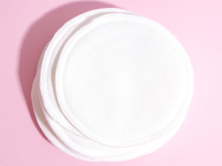 organic cotton pads on pink background. Zero waste, reusable, eco, makeup remover and washing concept. hard light, flat lay, close up