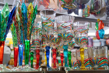 Many colorful fragile wine glasses. Colorful textured background for fragility and sensitivity...