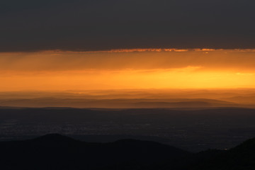 Fototapeta na wymiar Beautiful sunrise landscape over Carpathian mountain. Early morning horizon with dark orange sky