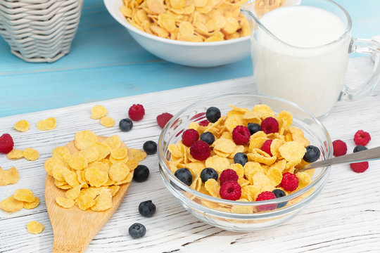 Healthy summer breakfast - cereal with milk and fresh berries in a bowl on the table. Light wooden background. Healthy eating concept