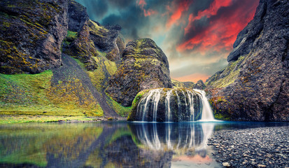 Fantastic Evening landscape with colorful skyover the waterfall during sunset. Amazing Icelandic...