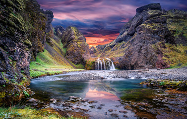 Wonderful nature of Iceland. fantastic view on canyon with green grass and icelandic moss near river with waterfall. Tipical Icelandic scenery. Stjornarfoss Waterfall during sunset. Wallpaper