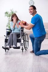 Disabled wife and young husband at home