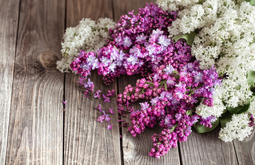 Background of lilac blooming on a wooden background.