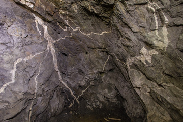 Underground old mica mine tunnel with collapsed wooden timbering