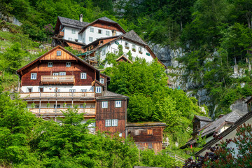 Traditional old house with partly wooden facade built into the rock high above the mountain village Hallstatt in the Salzkammergut region, OÖ, Austria