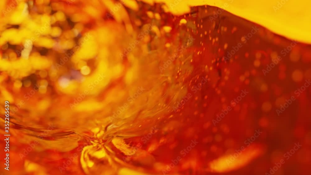 Poster beer with bubbles moves in a glass in slow motion. abstract water background. seamless loop 3d rende