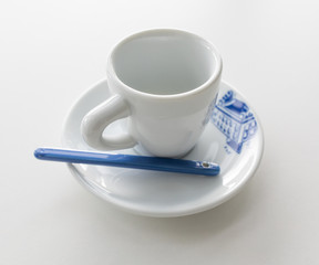 Empty white espresso cup with colored elements