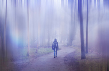 Woman walking in a surreal forest