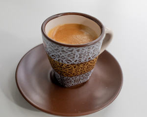 Espresso in a brown cup with a white print