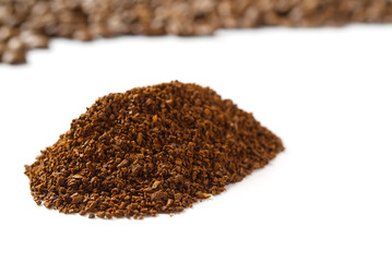 Pile of the ground coffee flakes isolated over the white background. pile of melted coffee