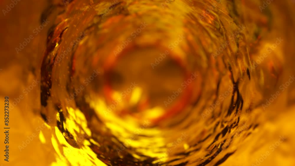 Poster beer with bubbles moves in a glass in slow motion. abstract water background. seamless loop 3d rende