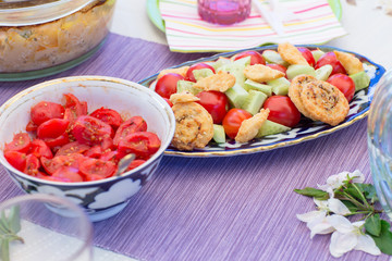 tomato salad and snacks on the table