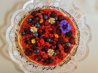 Dessert cake with Strawberry paste Raspberries blueberries and flowers