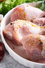 Uncooked chicken drumstick with spices and turmeric