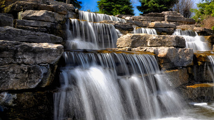 Richmond Hill, Ontario / Canada - May 08, 2019: View of waterfall in Richmond Green Sports Centre and Park. Beautiful, scenic and very attractive for visitors.