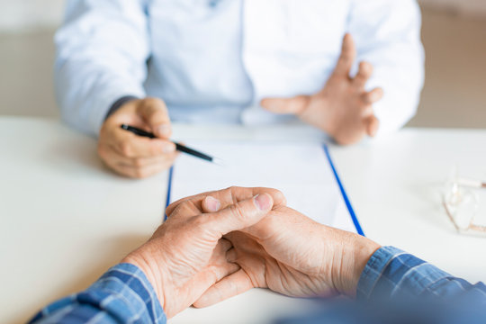 Patient And Doctor. The Doctor Tells The Patient About His Illness And The Possibilities Of His Medical Insurance.