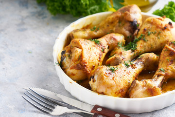 Fried chiken drumstick served in white bawl wiht spices, salad and turmeric