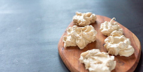 the process of creating Pavlova dessert, decorating the meringue with cream from the culinary bag