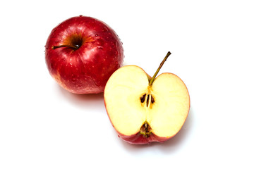Ripe red apples on a plate on a wooden background.